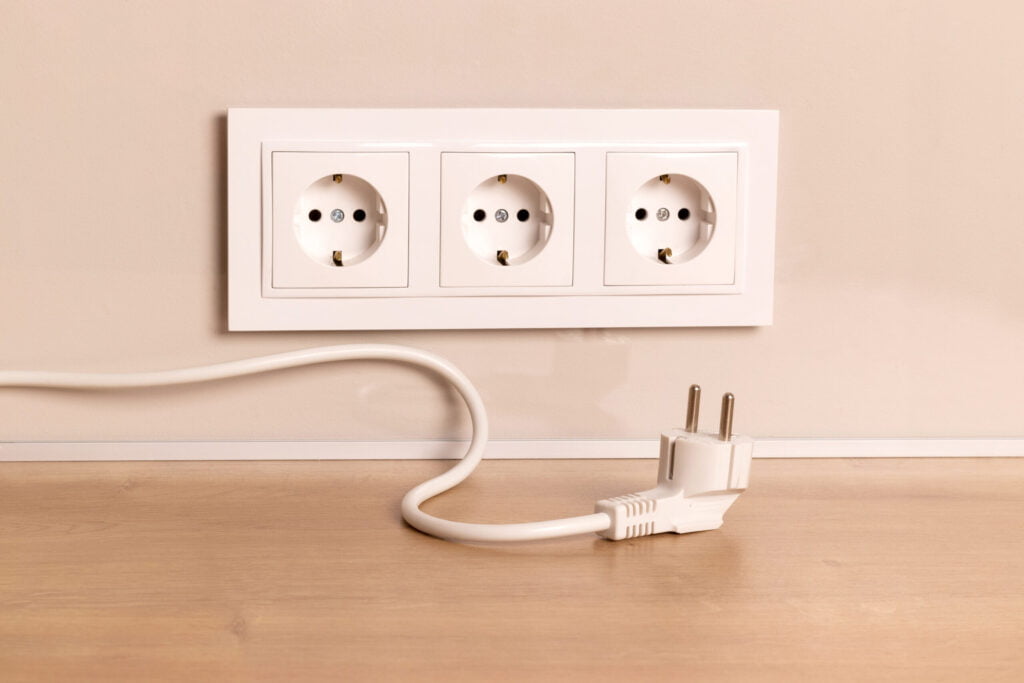 Unplugged power cord and electrical outlet for switch to outlet conversion.