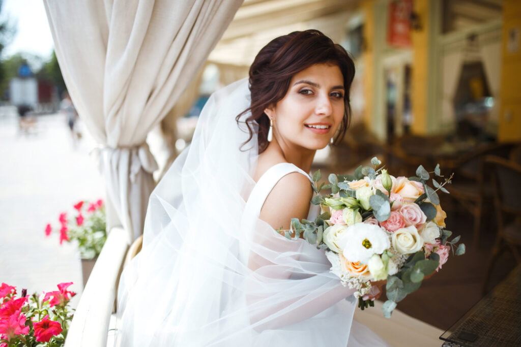 Bride with wedding flowers bouquet complementing wedding theme