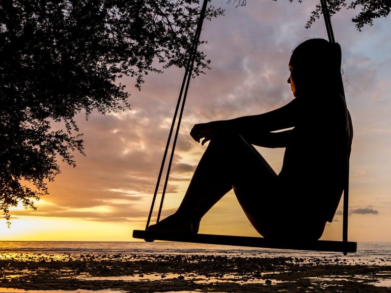 a person sitting on a swing