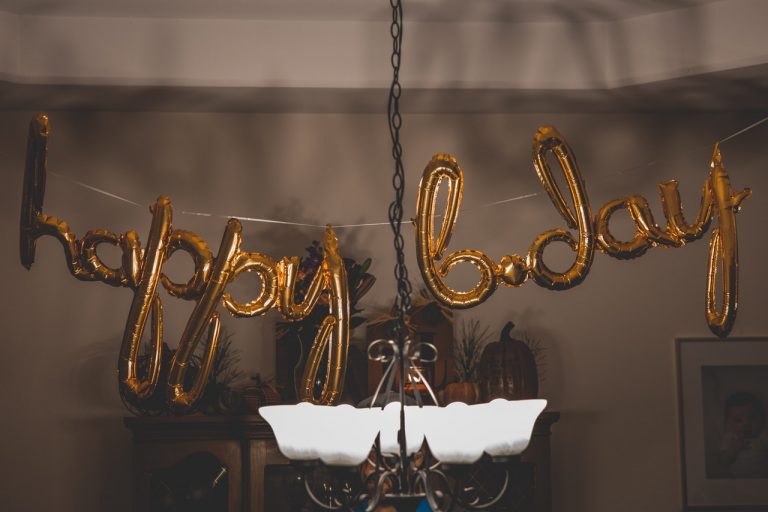 a gold framed necklace on a shelf