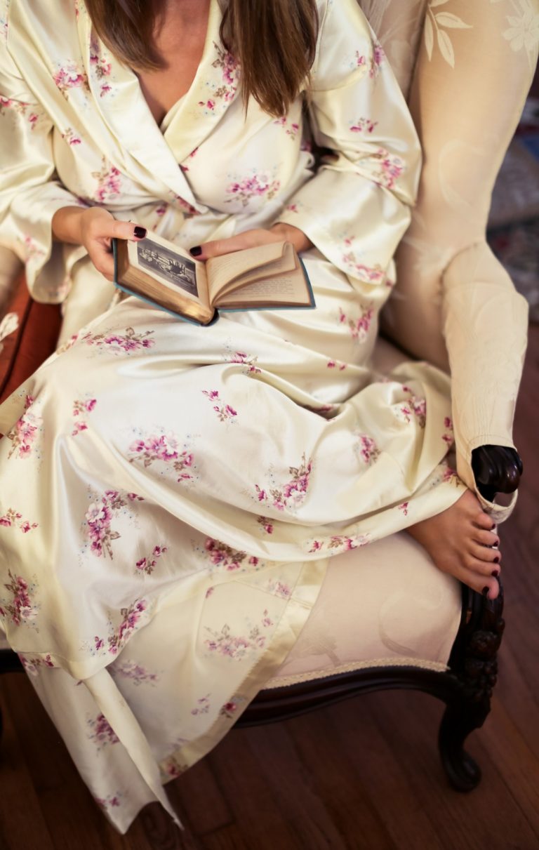 a woman in a dress holding a book