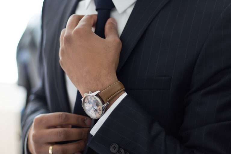 a man in a suit holding a black object