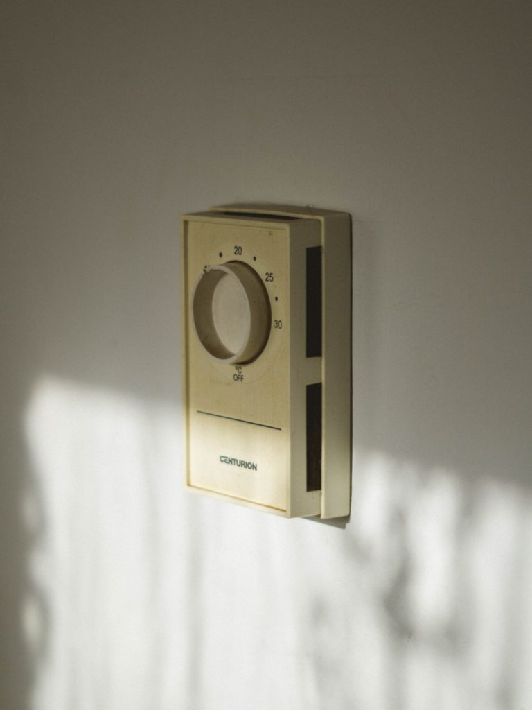 a white wall with a silver and black object on it