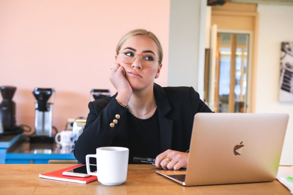 a woman on her phone and laptop