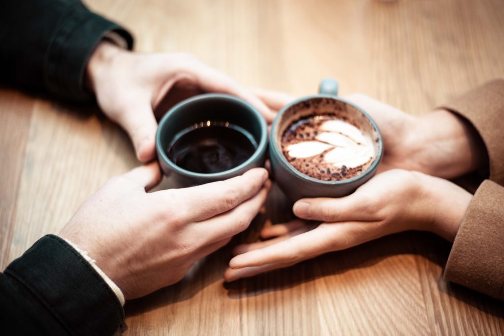 hands holding a cup of coffee