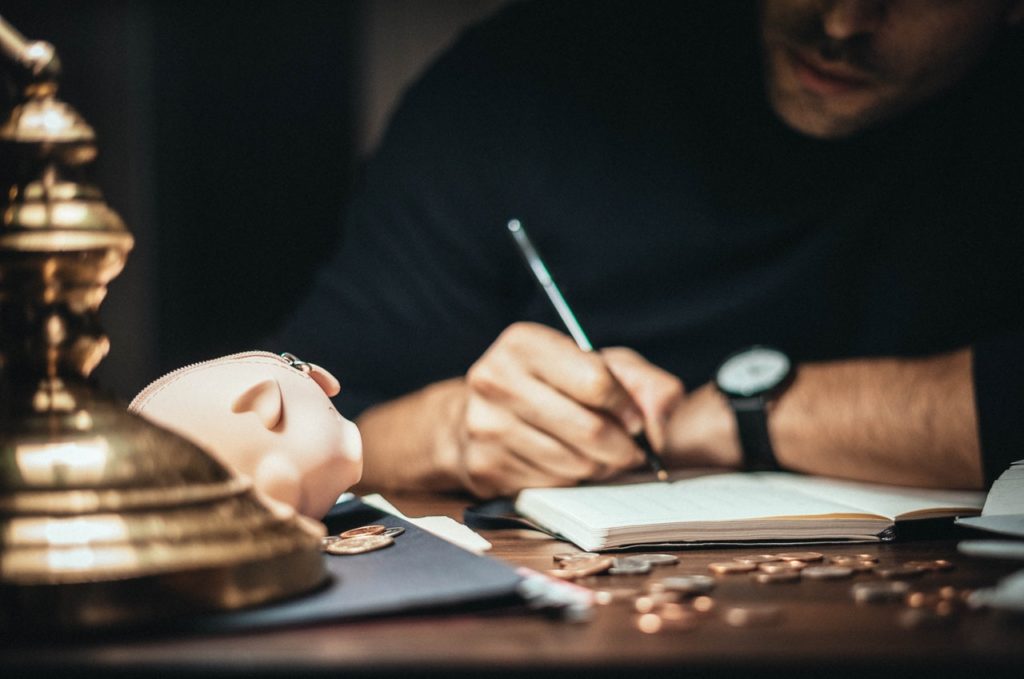 a man writing on a piece of paper