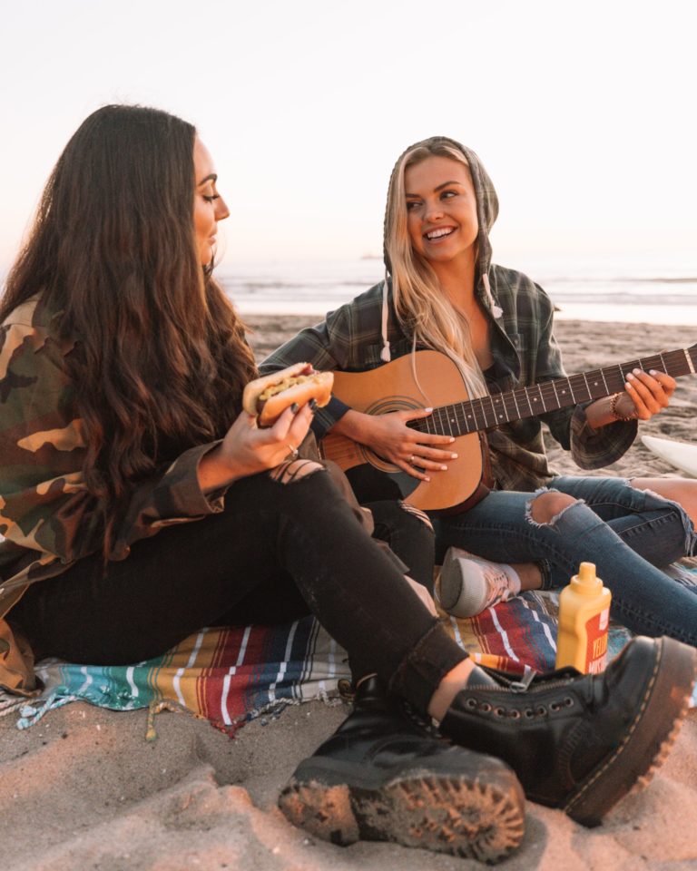 a couple of people playing guitars