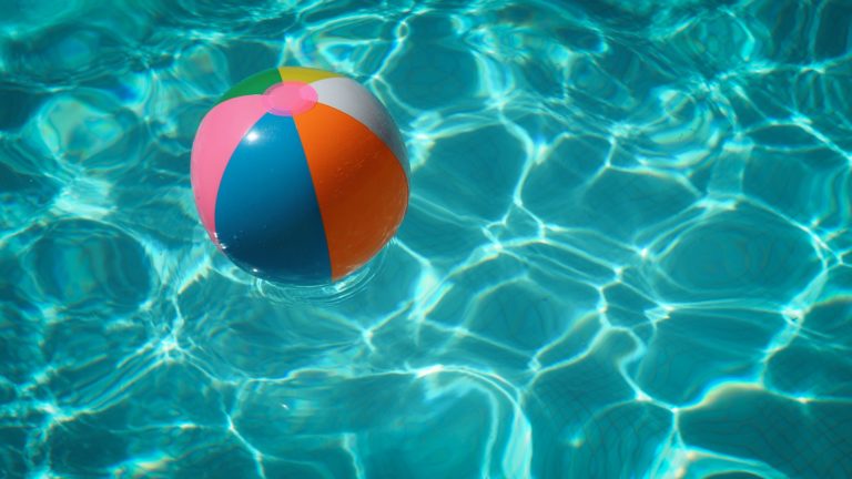 a red and white ball in a pool of water