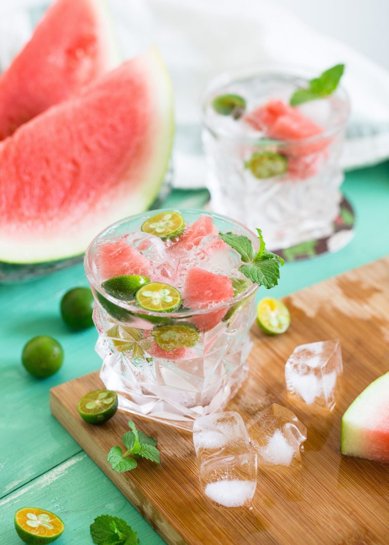 a glass with a pink and green object in it