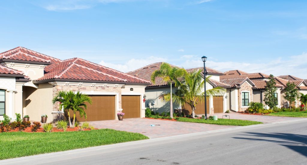 a house with a driveway and trees