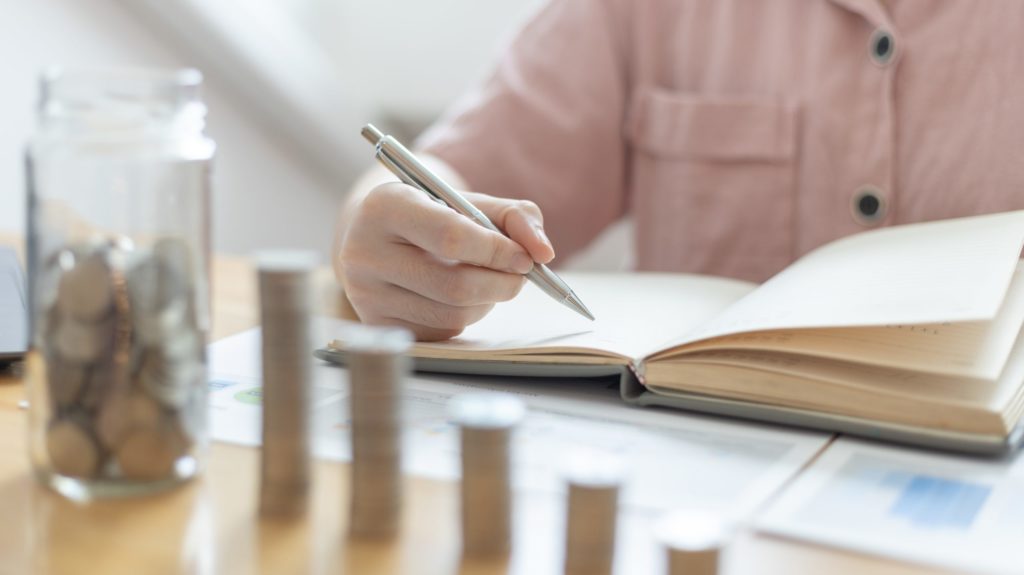 a person writing on a piece of paper