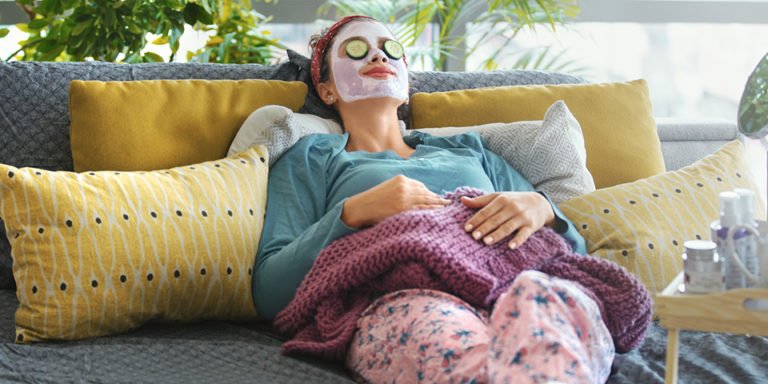 a person wearing a mask sitting on a couch