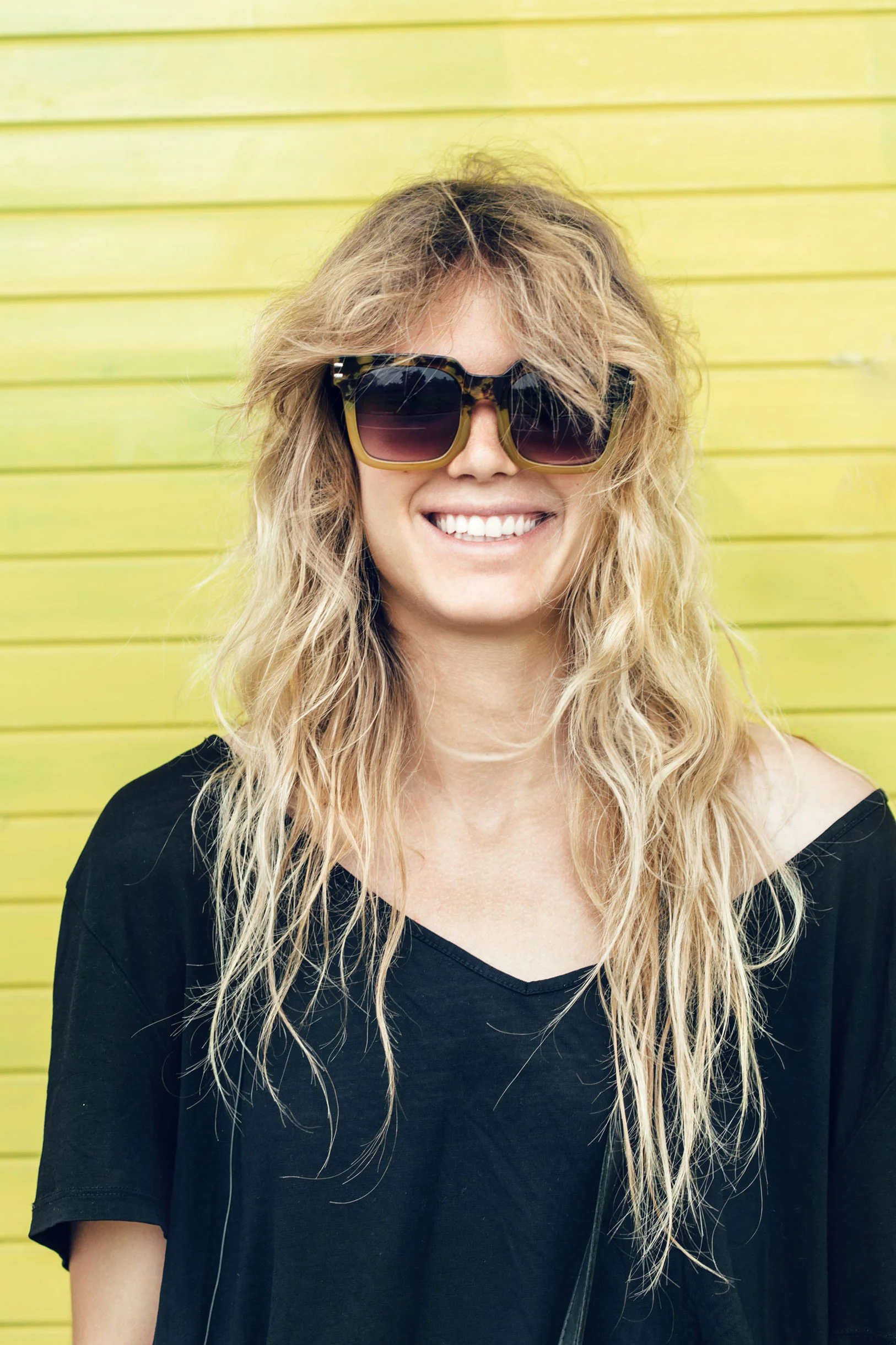 a woman with long hair wearing sunglasses