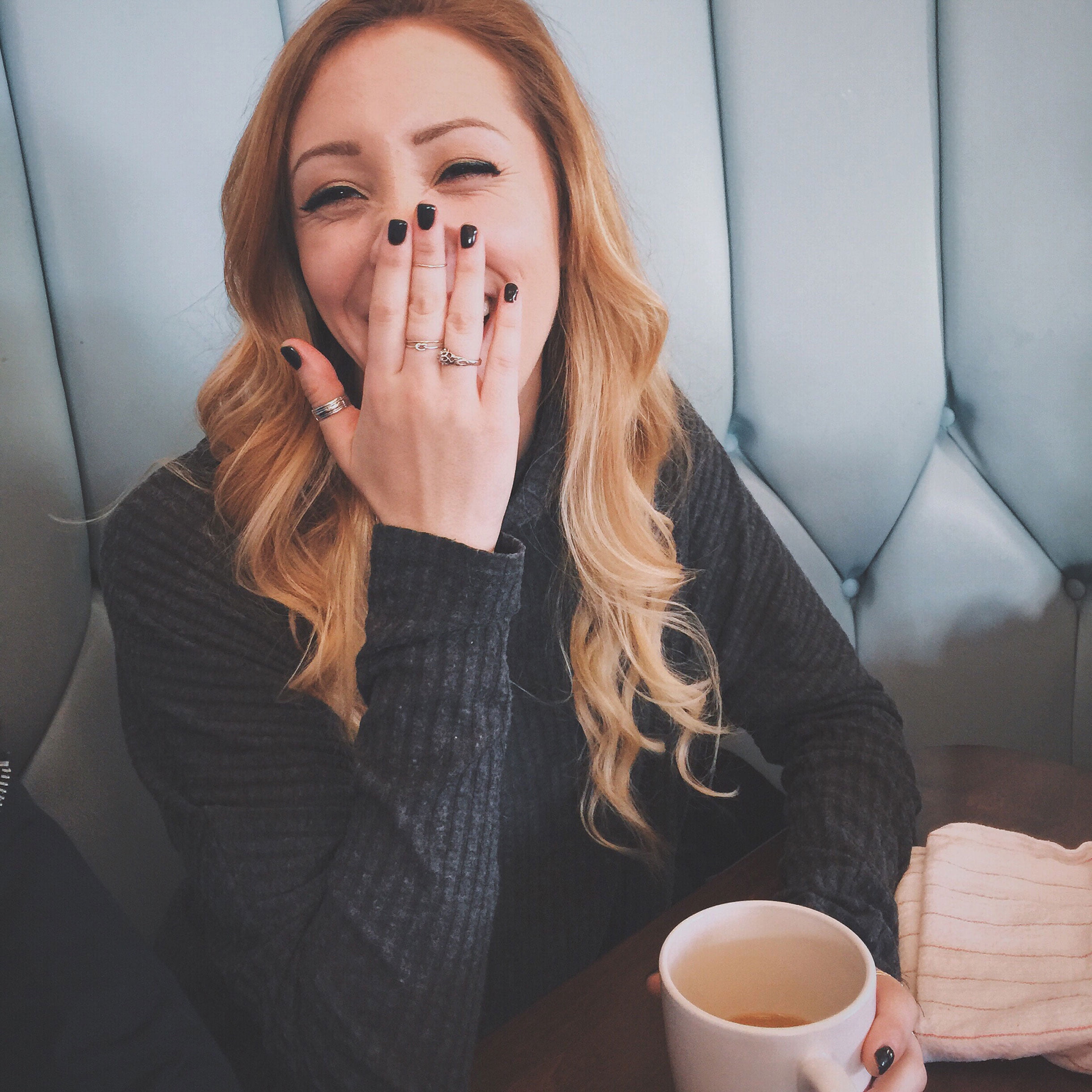 a woman with her hands on her face