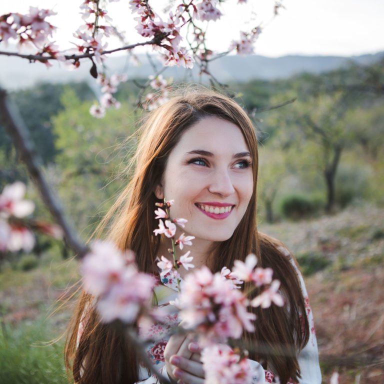 a woman smiling with flowers