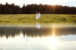 two people standing on a grass field