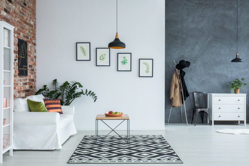 a room with a couch and a table with a rug