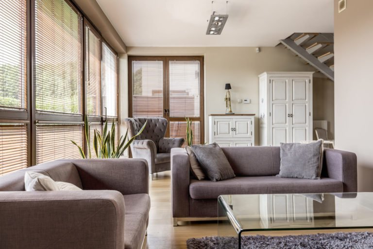 a living room with a table and couches