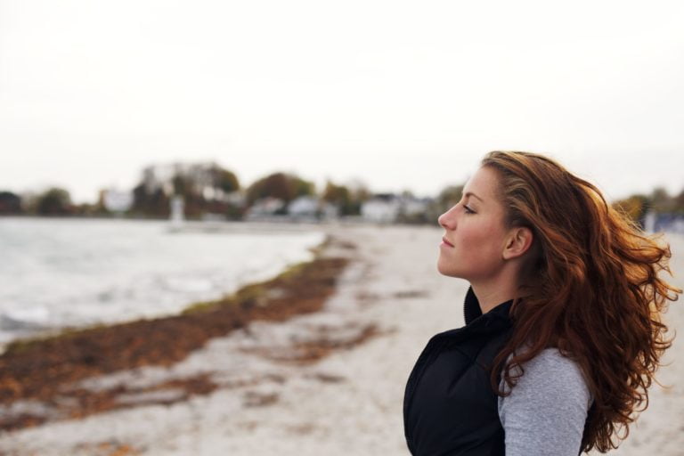 a woman standing on a beach