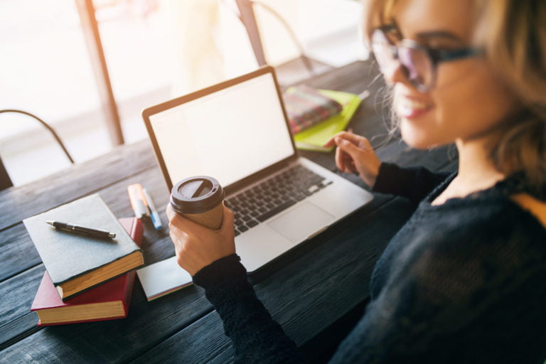 a woman and a man looking at a laptop