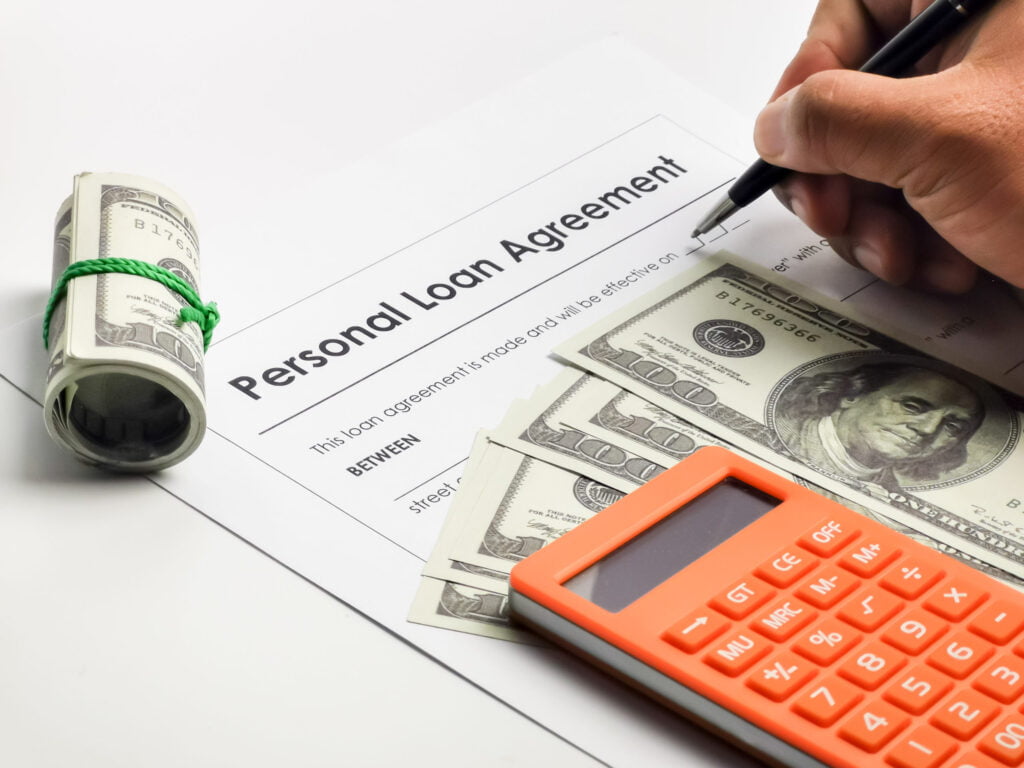 uncategorized, filling up personal loan agreement form with a pen utc scaled