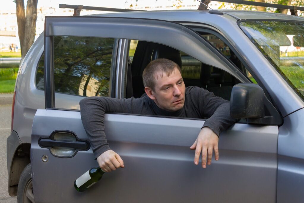 life advice, drunk driver with a bottle of alcohol falls out of utc scaled