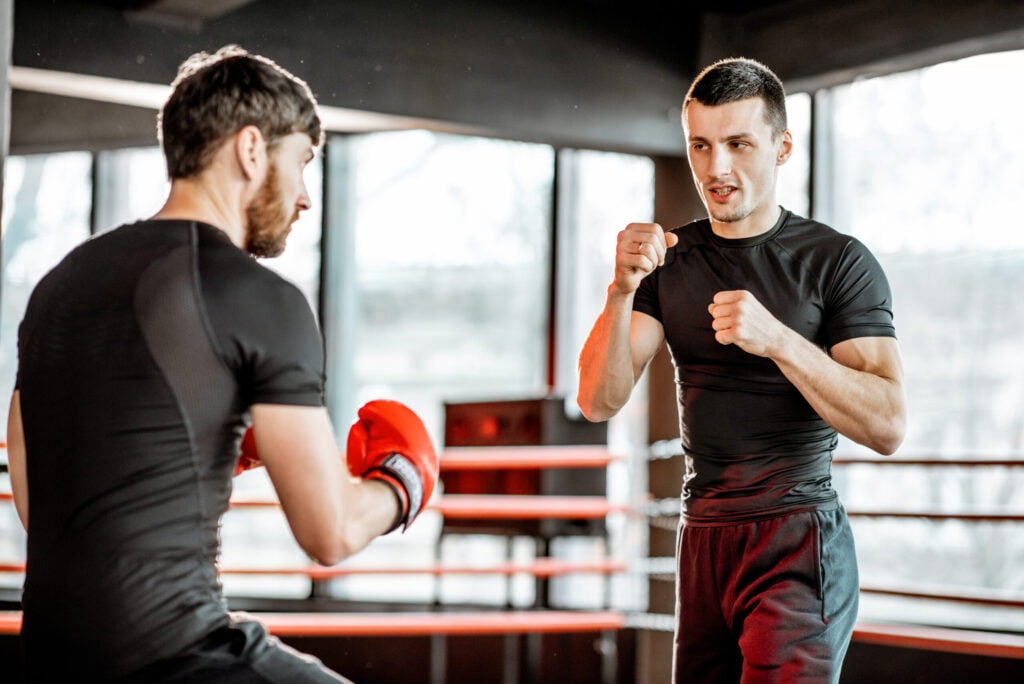 life advice, boxing trainer with a man boxing at the gym utc scaled