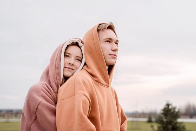 style, happy young loving couple wearing hoods embracing utc scaled