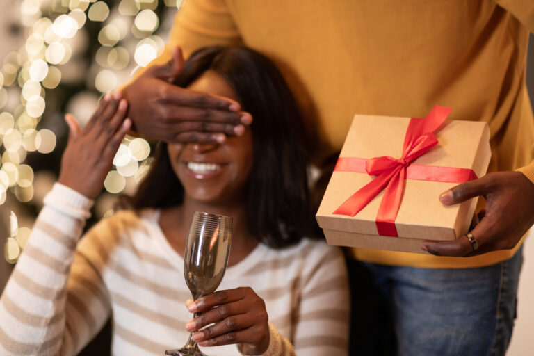 life advice, african man giving woman gift covering eyes celebr utc scaled