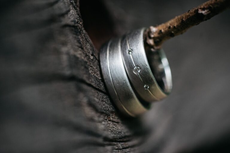 style, closeup of wedding silver rings hanging from tree utc scaled